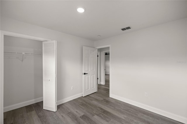 unfurnished bedroom featuring wood-type flooring and a closet