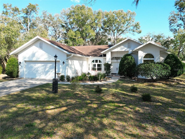 ranch-style house with a garage and a front lawn