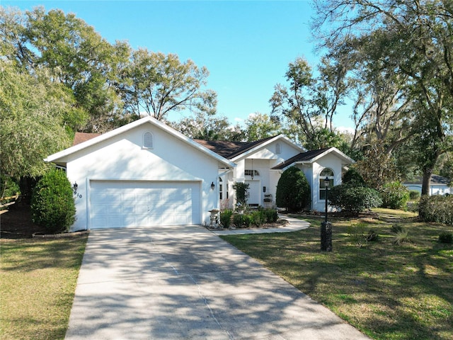 ranch-style house featuring a garage and a front lawn