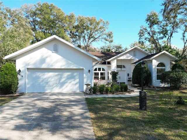 single story home featuring a garage and a front lawn