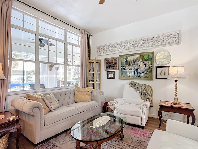 living room featuring wood-type flooring and ceiling fan