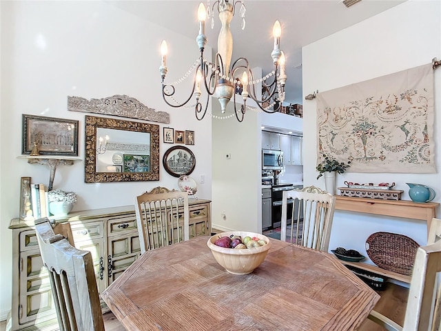 dining space with an inviting chandelier