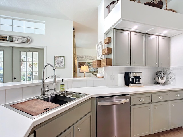 kitchen featuring sink, stainless steel dishwasher, and gray cabinetry