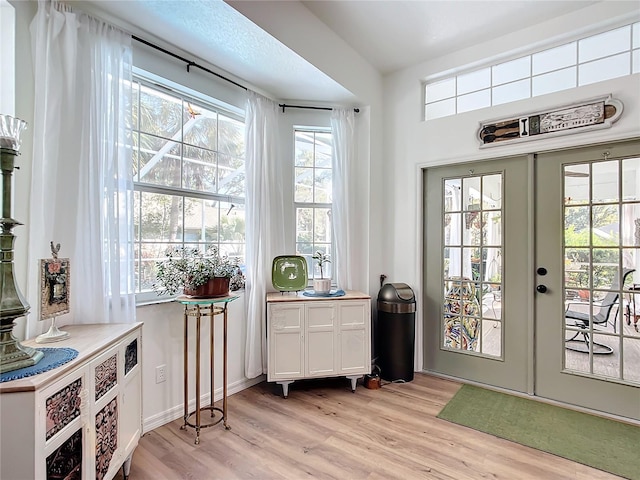 entryway featuring light wood-type flooring and french doors