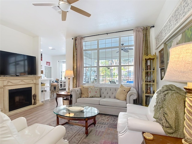 living room featuring ceiling fan and light hardwood / wood-style flooring