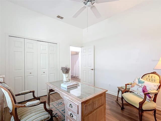 office with wood-type flooring and ceiling fan