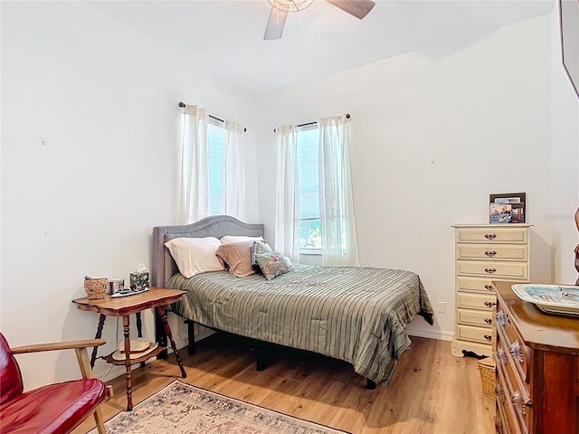 bedroom with ceiling fan and light hardwood / wood-style floors