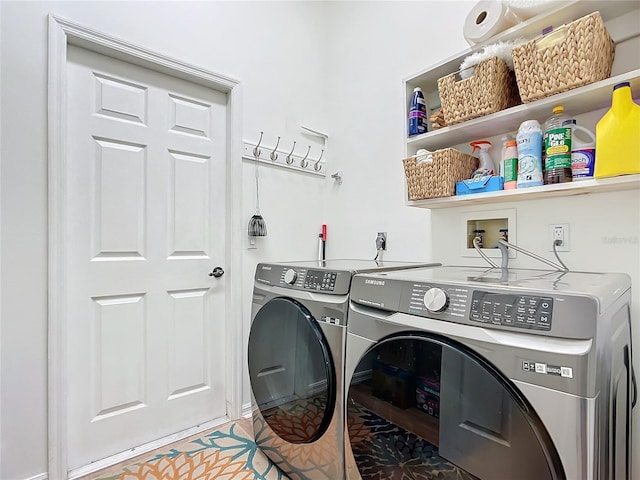 clothes washing area with separate washer and dryer