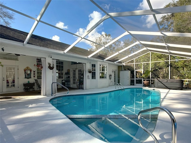 view of pool featuring french doors, a lanai, and a patio area