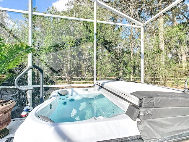 view of pool featuring a hot tub and a lanai