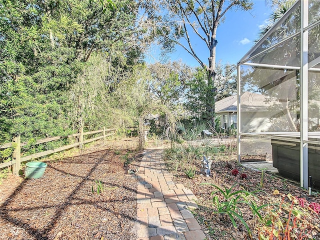 view of yard with glass enclosure