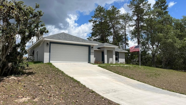 view of front of home featuring a garage and a front yard