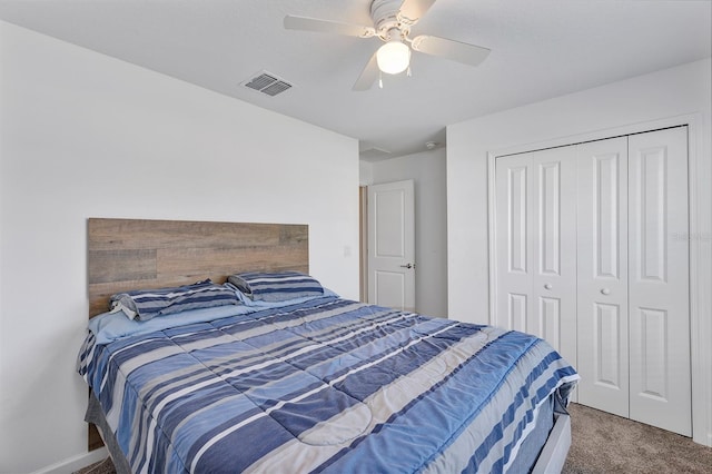 carpeted bedroom with ceiling fan and a closet