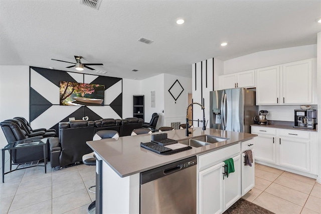 kitchen featuring stainless steel appliances, sink, a center island with sink, and white cabinets