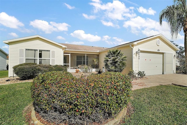 ranch-style home with a garage and a front yard