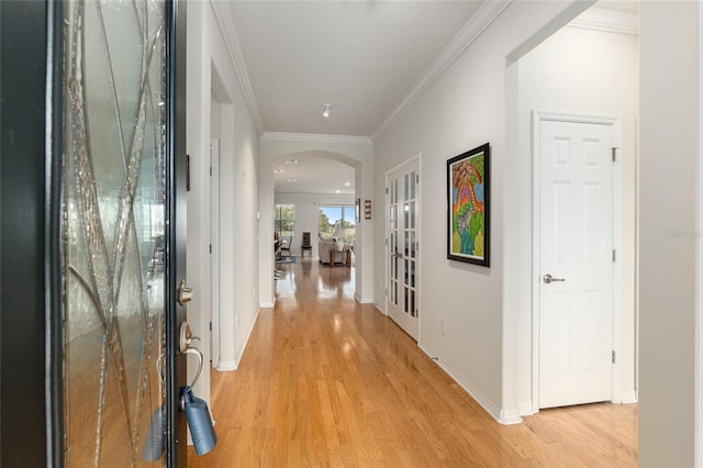 hall featuring crown molding and light wood-type flooring