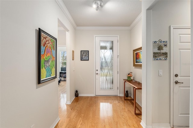 doorway to outside featuring ornamental molding and light hardwood / wood-style floors