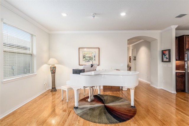 miscellaneous room featuring crown molding and light hardwood / wood-style flooring