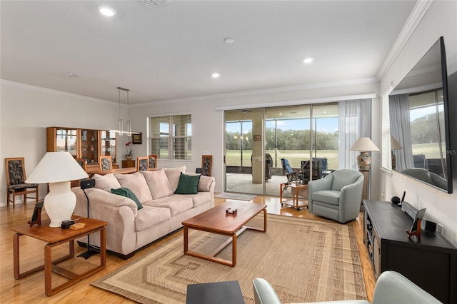 living room with crown molding and light hardwood / wood-style floors