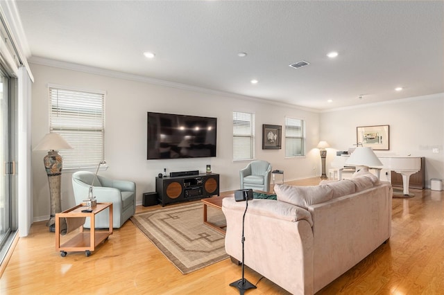 living room featuring crown molding, a textured ceiling, and light hardwood / wood-style floors