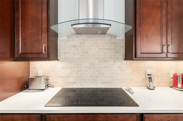 kitchen featuring black electric cooktop, island exhaust hood, and decorative backsplash