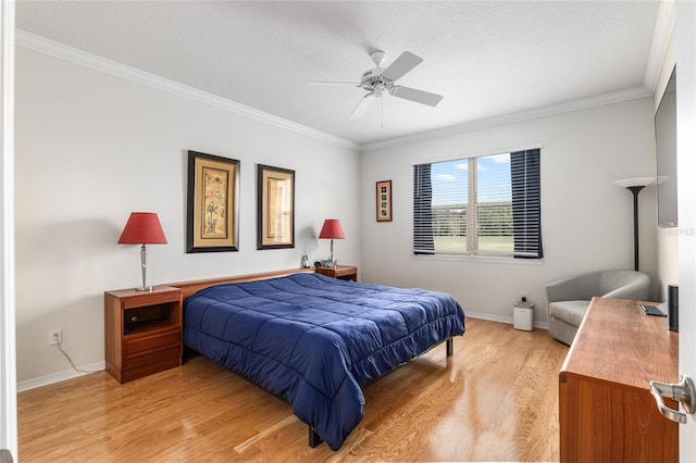 bedroom featuring ceiling fan, ornamental molding, light hardwood / wood-style floors, and a textured ceiling