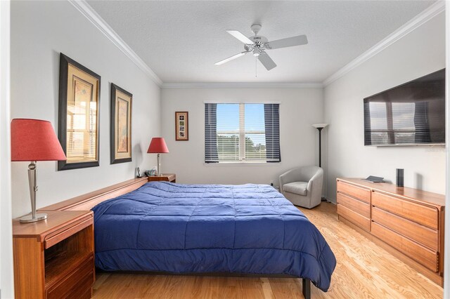 bedroom with ornamental molding, hardwood / wood-style floors, a textured ceiling, and ceiling fan