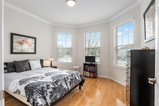 bedroom with crown molding and light hardwood / wood-style floors