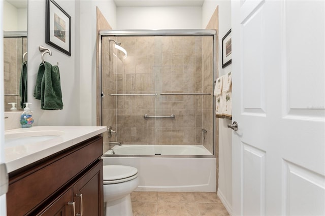 full bathroom with vanity, combined bath / shower with glass door, tile patterned floors, and toilet