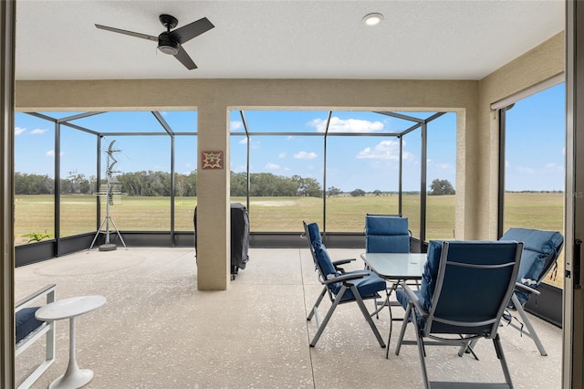 sunroom featuring ceiling fan