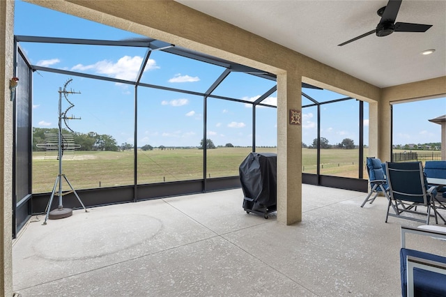 sunroom / solarium featuring ceiling fan