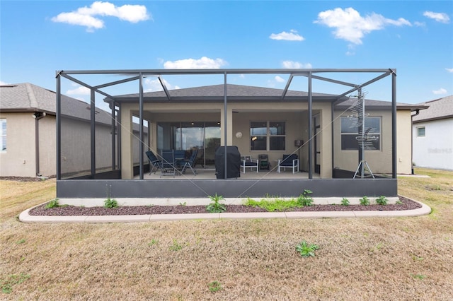 back of property featuring a patio, a lanai, and a lawn