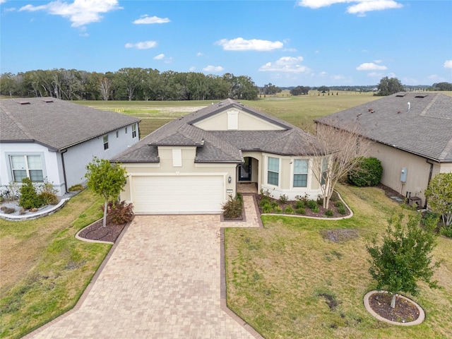 view of front of property with a garage and a front lawn