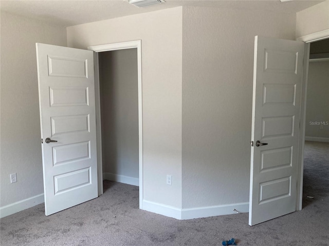 unfurnished bedroom featuring light colored carpet