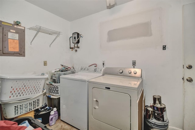 clothes washing area with laundry area, electric panel, and washer and clothes dryer
