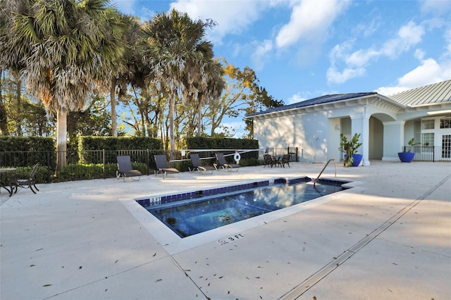 pool featuring a patio and fence