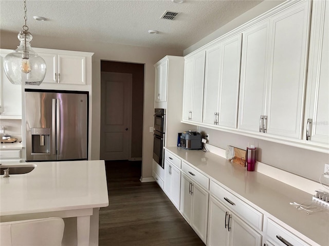 kitchen with visible vents, white cabinets, light countertops, and stainless steel fridge with ice dispenser