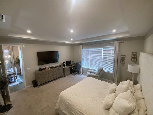 bedroom featuring light carpet, baseboards, a raised ceiling, and recessed lighting