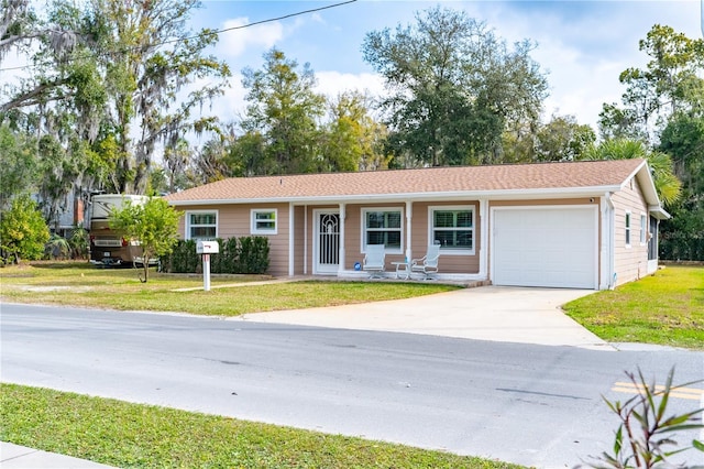 ranch-style home with an attached garage, driveway, and a front lawn