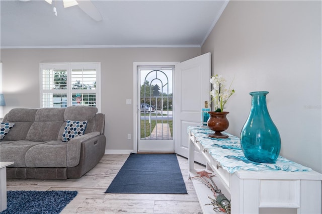 entryway featuring crown molding, baseboards, and light wood-type flooring