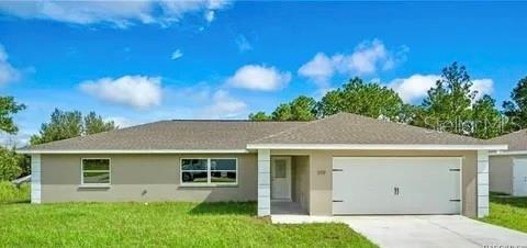 ranch-style home with a garage and a front lawn