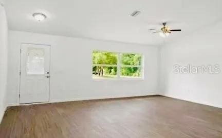 spare room with dark hardwood / wood-style flooring