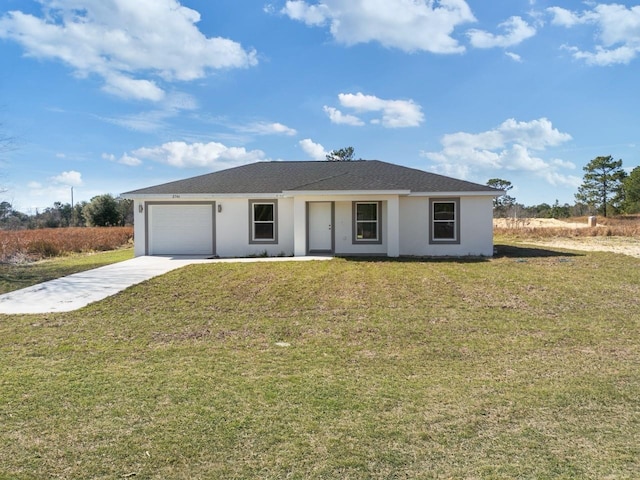 ranch-style house featuring a garage and a front lawn