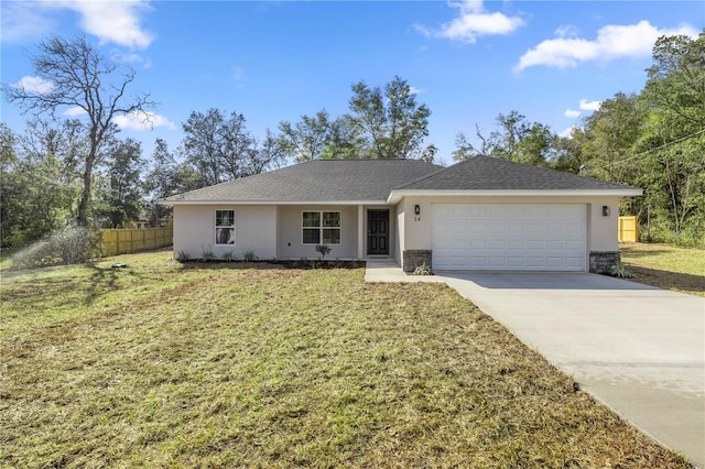 single story home with a garage and a front lawn