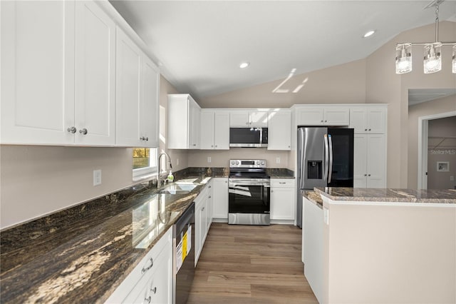 kitchen featuring decorative light fixtures, white cabinetry, sink, dark stone countertops, and stainless steel appliances