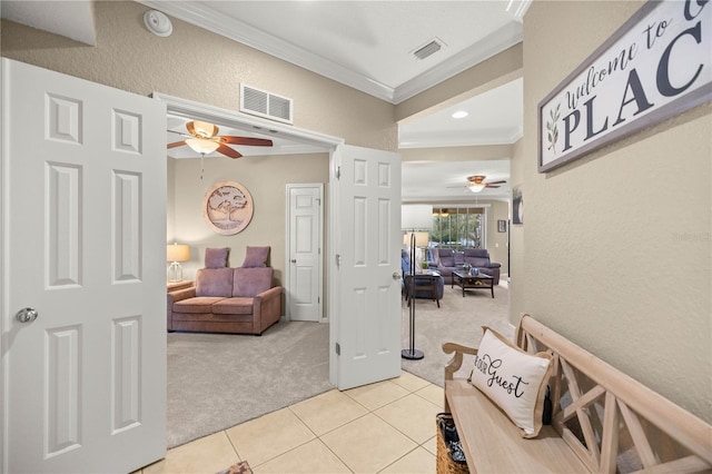 hall with ornamental molding and light carpet