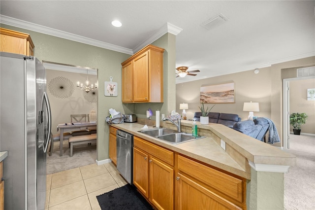 kitchen featuring sink, crown molding, light tile patterned floors, stainless steel appliances, and kitchen peninsula