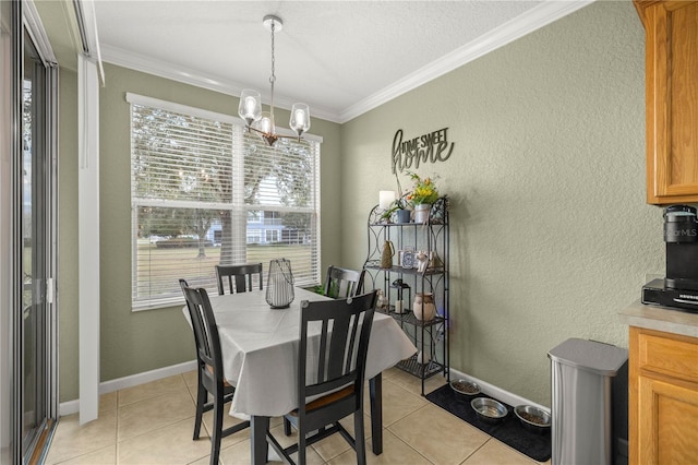 dining room with ornamental molding, light tile patterned flooring, and a notable chandelier