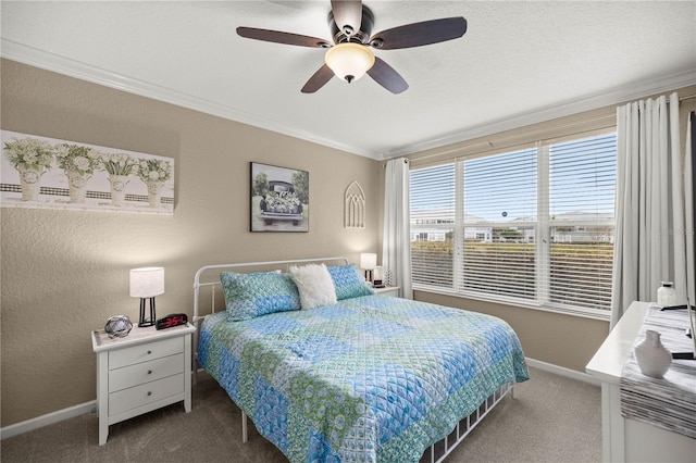 carpeted bedroom with a textured ceiling, ornamental molding, and ceiling fan