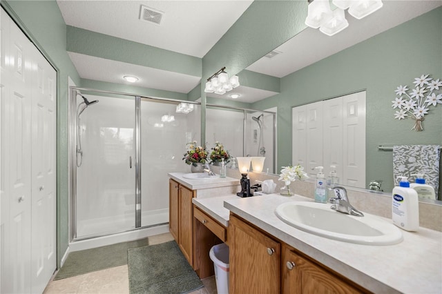 bathroom featuring vanity, tile patterned flooring, and walk in shower